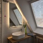 Badezimmer mit Waschtisch, Spiegel und Dachfenster