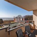 Terrace with seating and sea view towards the beach and ocean.