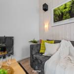 Ein Wohnbereich mit Sofa, Kamin und Wandbild.