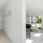 Hallway with living room. Living area with TV, seating, and garden view.
