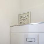 Wall with picture: DREAM IT. WISH IT. DO IT. and switch.