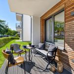 Terrace with seating and view of green lawn area.