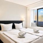 Bedroom with double bed, window, and bedding.