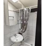 Bathroom with shower, sink, and mirror cabinet