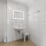 Badezimmer mit Waschbecken, Spiegel und Heizung
