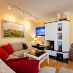 Wohnzimmer mit Sofa, Fernseher und Kamin. Wandbilder und Dekorationen.