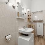 Bathroom with sink, mirror, and towel rack.
