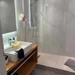 Bathroom with shower, sink, and mirror