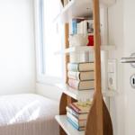 Bedroom with bed, bookshelf, and door
