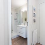 Bathroom with shower, sink, and mirror