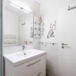 Bathroom with sink, mirror, and shower