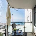 Balcony with seating and sea view.