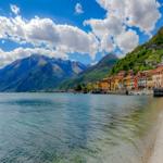 Village by lake with mountains and clear water