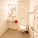 Badezimmer mit Waschbecken, Toilette und Heizkörper
