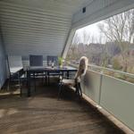 Terrace with table, chairs, and view of the surroundings.