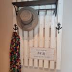 Wall rack with hat and dress, sign with sea symbols
