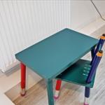 Childs desk and chair with colored pencil legs.
