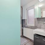 Bathroom with sink, mirror, and window