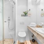 Bathroom with shower, toilet, and sink with mirror