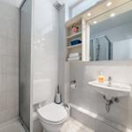 Bathroom with shower, toilet, and sink with mirror