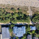 Aerial view of vacation home with beach and dunes.