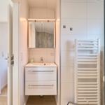 Badezimmer mit Waschbecken, Spiegel und Heizkörper