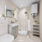 Badezimmer mit Dusche, Waschbecken und Toilette. Moderne Einrichtung und hell.