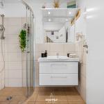 Bathroom with shower, sink, and mirror