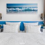 Bedroom with bed, wall art, and nightstands