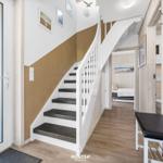House with staircase, entrance area, and view into bedroom