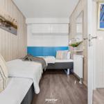 Bedroom with bed, wall art, and mirror