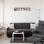 Living room with sofa, recliner, and wall decoration OSTSEE.