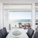 Dining room with sea view and balcony seating area.