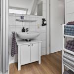 Bathroom with sink, mirror, and towel rack.
