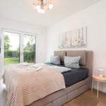 Bedroom with bed, TV, and window to the garden.