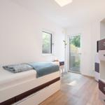 Bedroom with bed, wardrobe, and window to terrace.