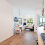 Kitchen with wooden countertop, dining area with table and chairs, view of terrace