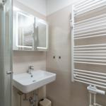 Bathroom with sink, mirror cabinet, and heater