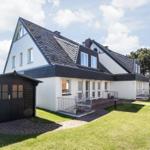 House with attic, garden and garage. Red brick path and bike racks.