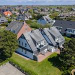 Modern house with balcony and garden in quiet residential area with view of surroundings.