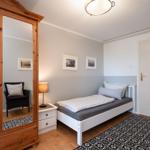 Bedroom with bed, wardrobe, and rug