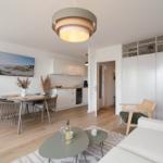 Living and dining area with kitchenette, dining table, and seating.