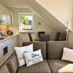 Living and kitchen area with sofa, kitchenette, and window