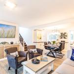 Wohn-/Essbereich: Sofa, Smart-TV, Essbereich, Treppenaufgang zur Dachterrasse, Zugang zum Balkon