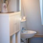 Bathroom with sink, mirror, and small window