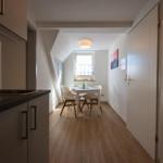 Kitchen with dining area, wooden floor, and window