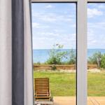 Through the window, you can see the beach and the sea.