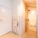 Bathroom with shower, heater, and toilet