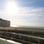 View of the sea and a building from the terrace.