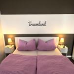 Bedroom with double bed, two nightstands, and wall decor.